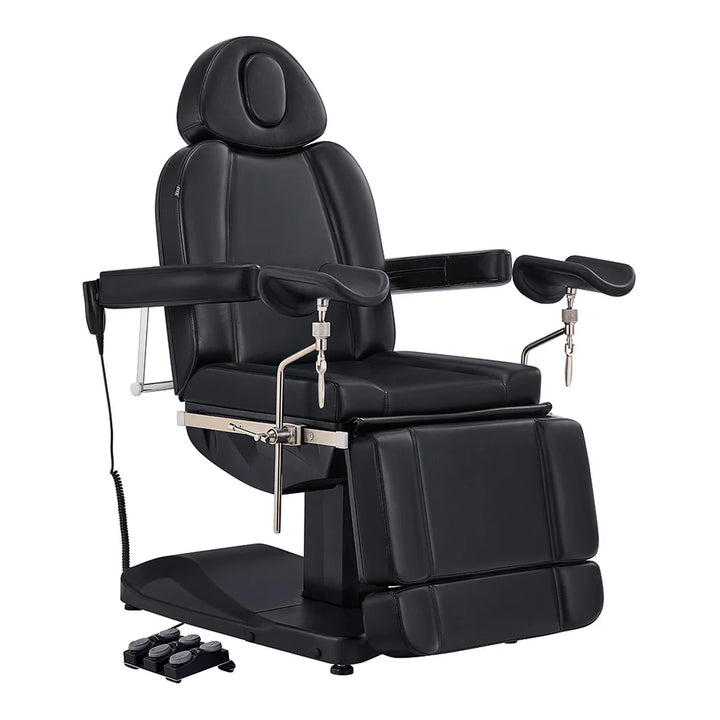 All-black electric medical and esthetician chair featuring adjustable stirrup armrests, extendable leg rests, and a multi-switch foot pedal.