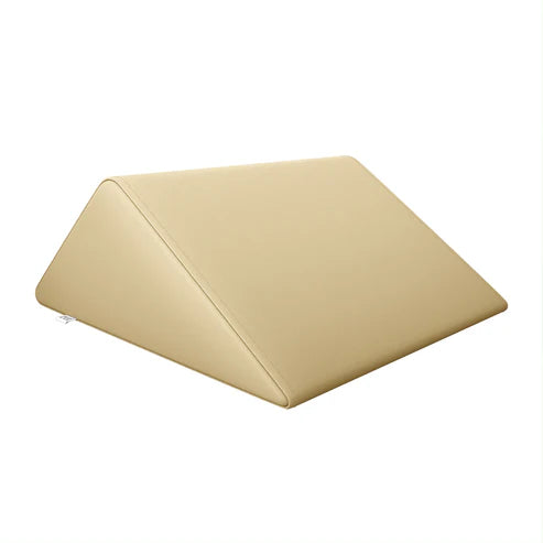 Beige triangle massage bolster wedge pillow by DIR for physical therapy and massage tables.